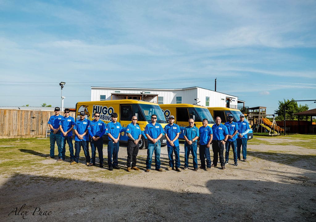 The Hugo Plumbing team in front of the fleet in Houston